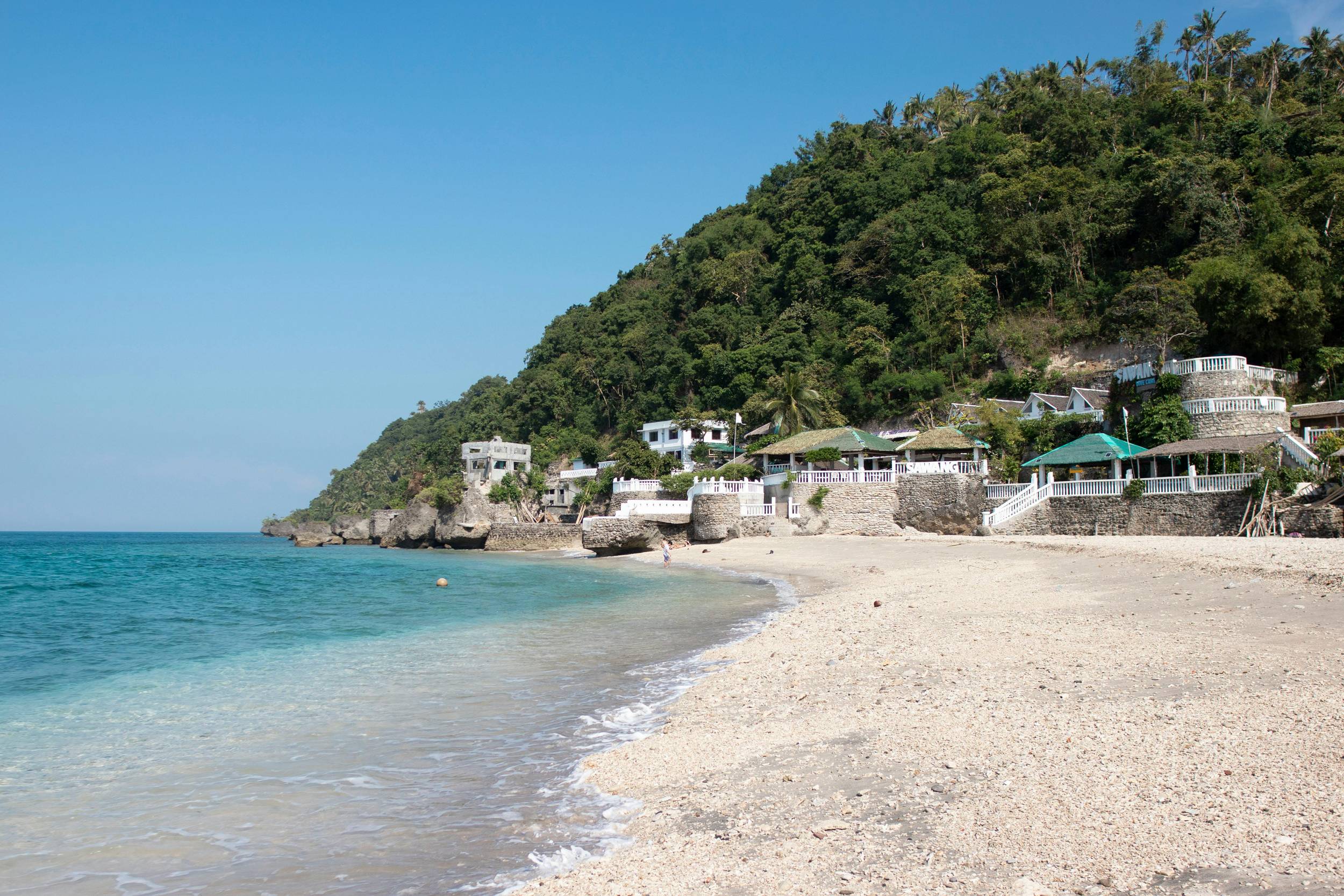 Tropical view of Bantayan Beach with white sand and clear blue water