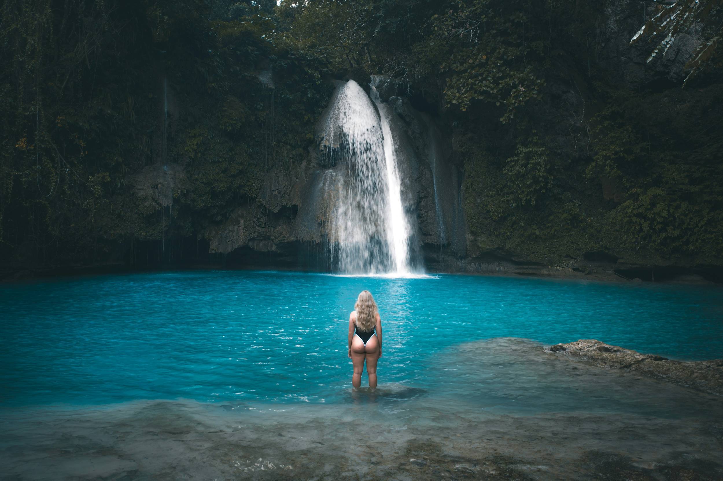 Woman overlooking Kawasan Falls in Cebu, Philippines